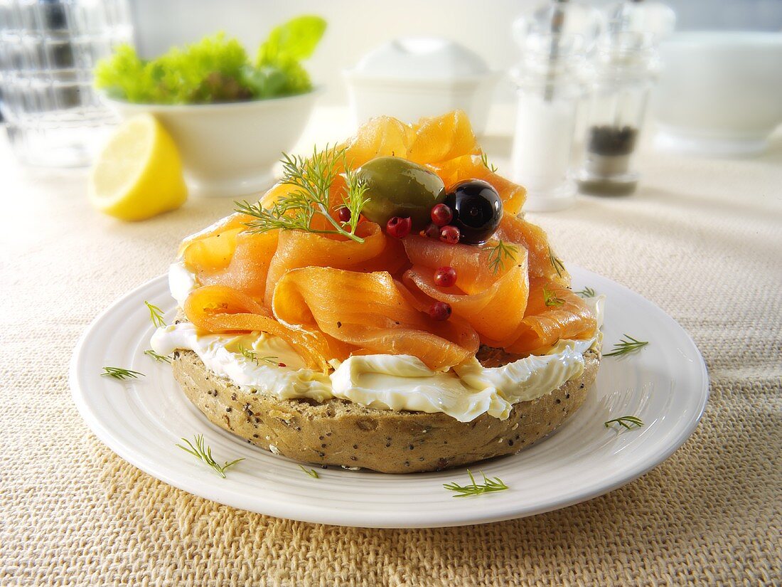 Bagel topped with cream cheese and smoked salmon