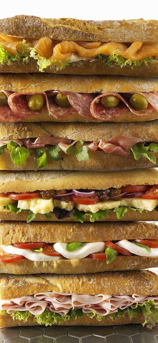 Several baguette sandwiches, in a pile