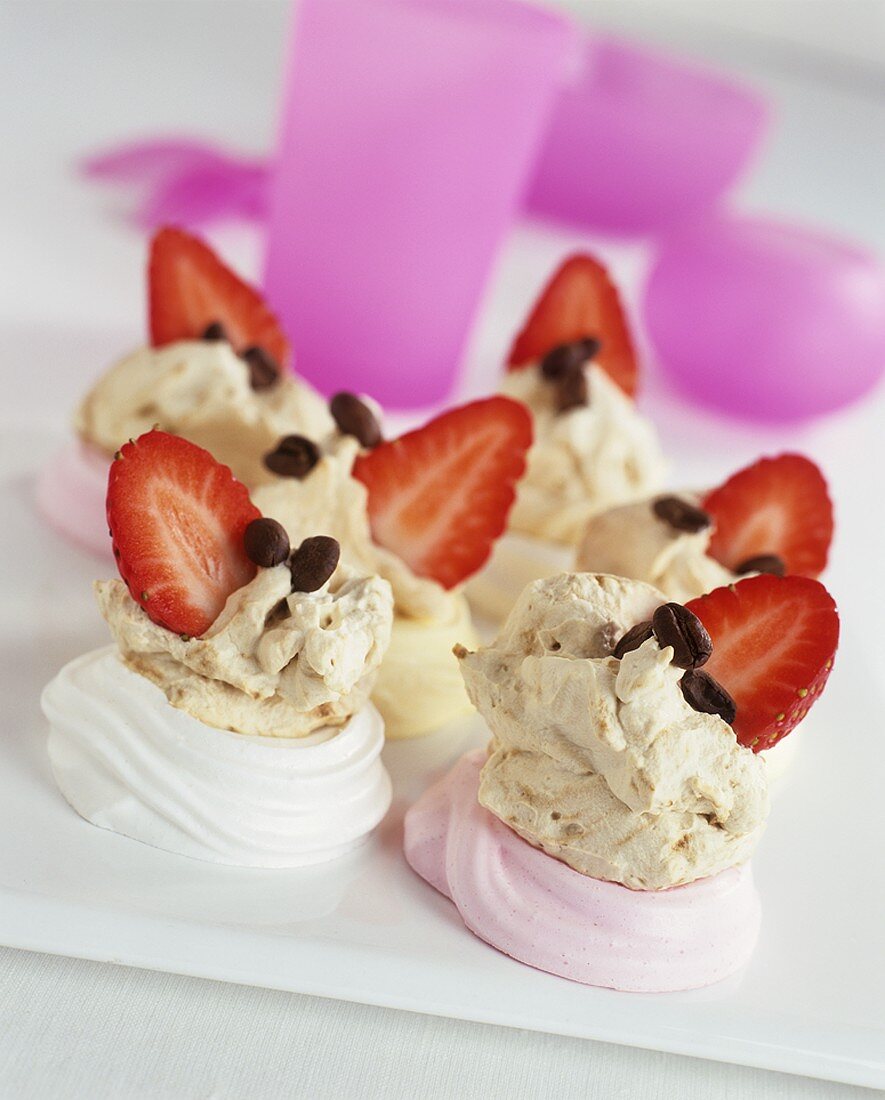 Cream meringues with coffee beans and strawberries