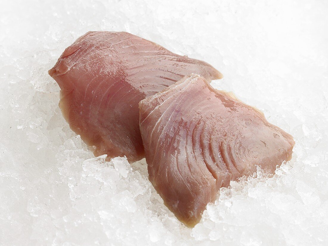 Two tuna steaks on crushed ice