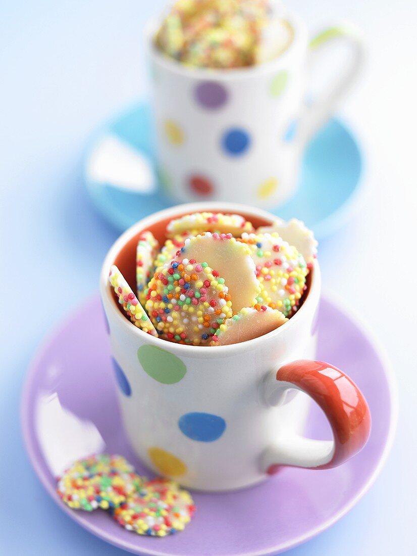 White gems (white chocolate buttons with sprinkles) in cups