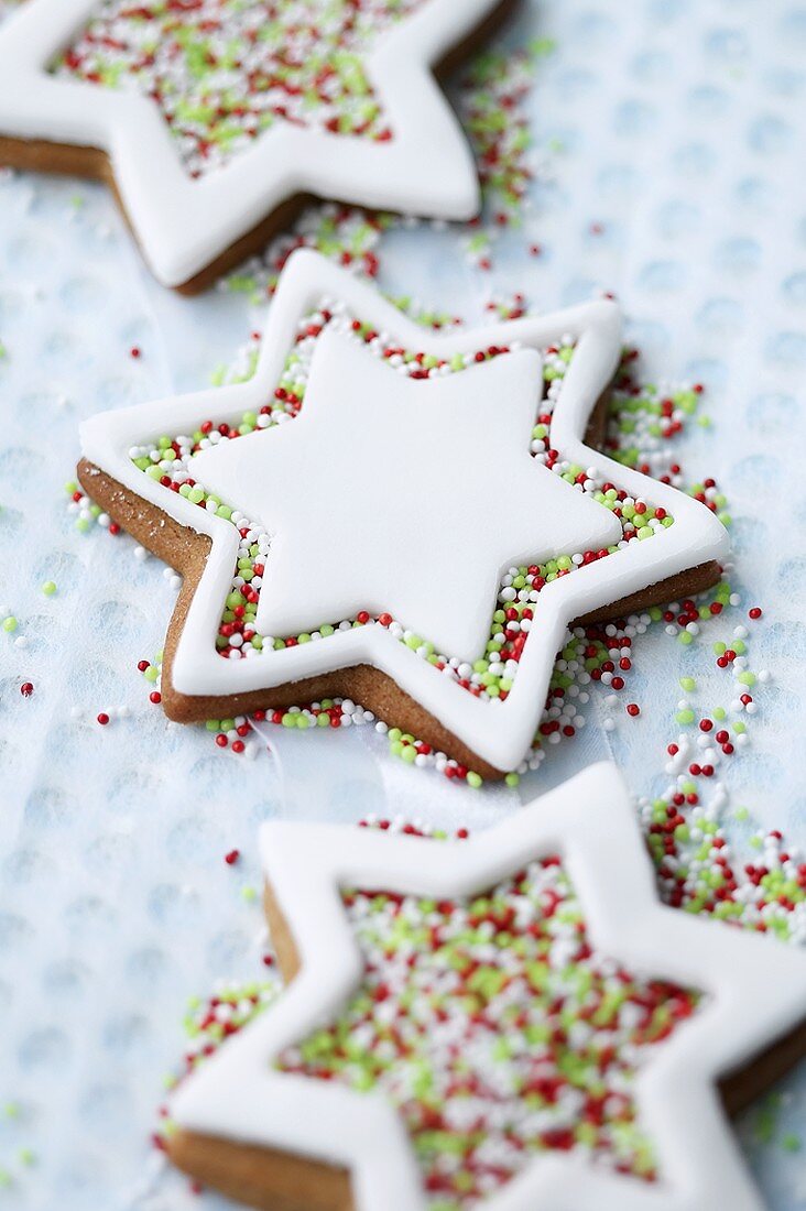 Iced star-shaped biscuits with hundreds and thousands