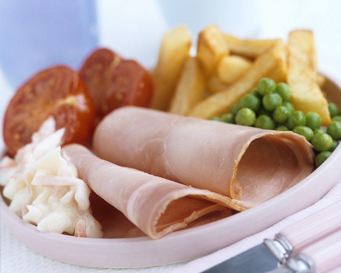 Ham with chips, peas and tomatoes