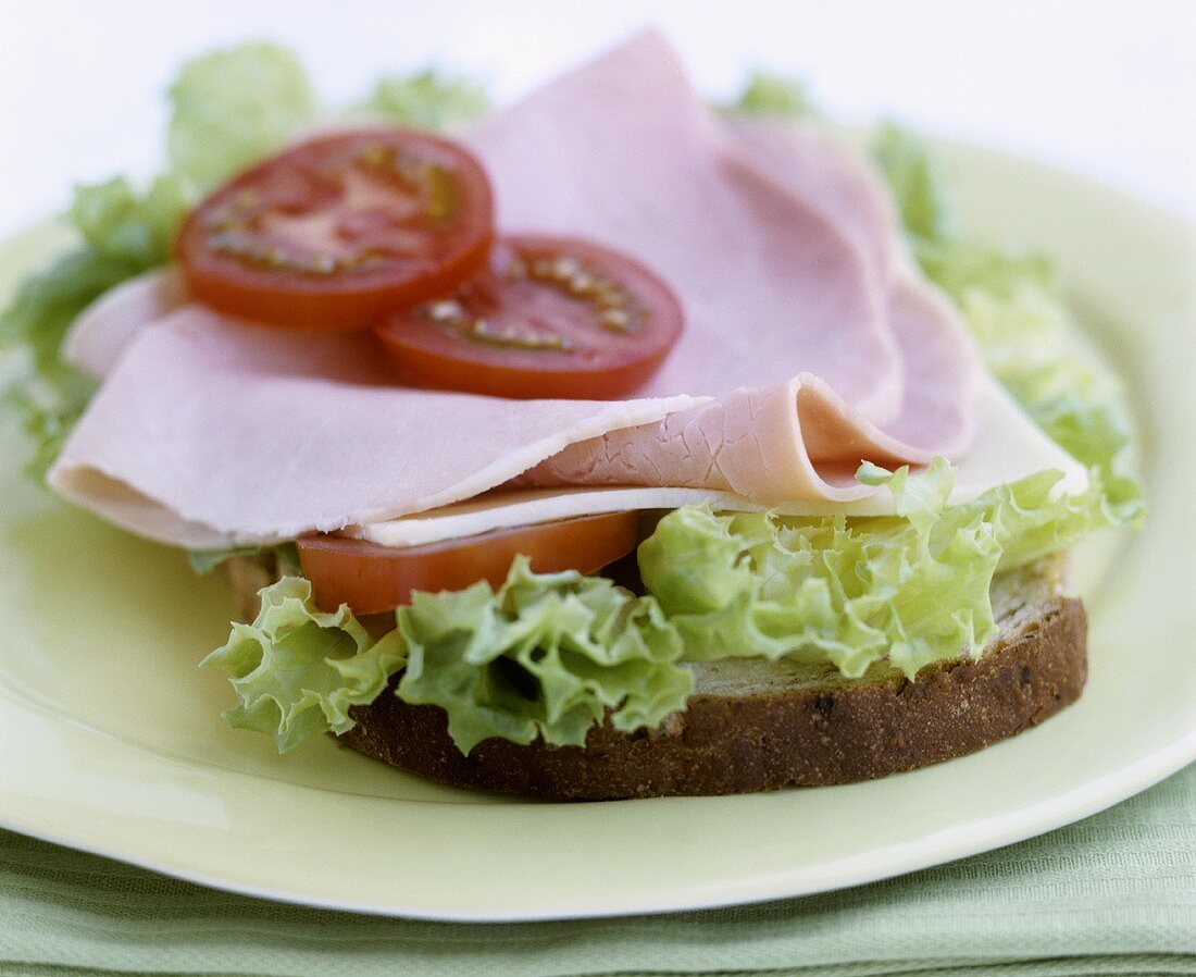 Open ham, lettuce and tomato sandwich