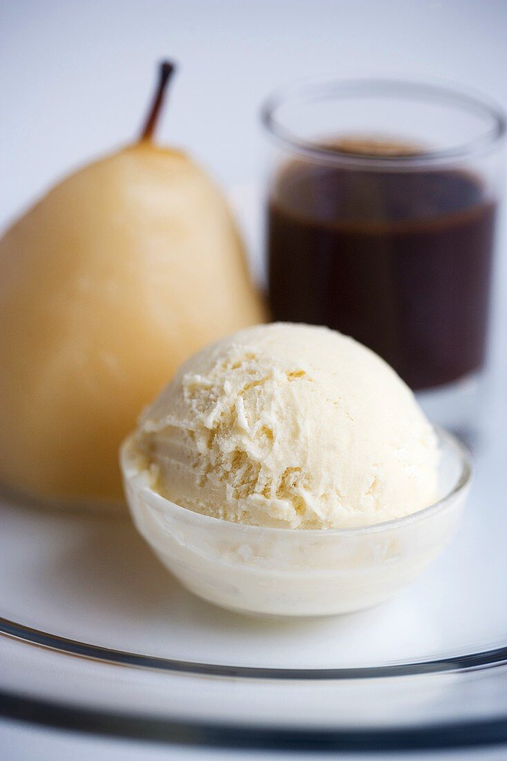 Baked pear with vanilla ice cream and chocolate sauce