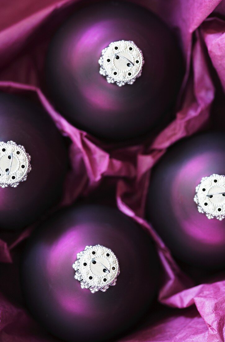 Four purple Christmas baubles