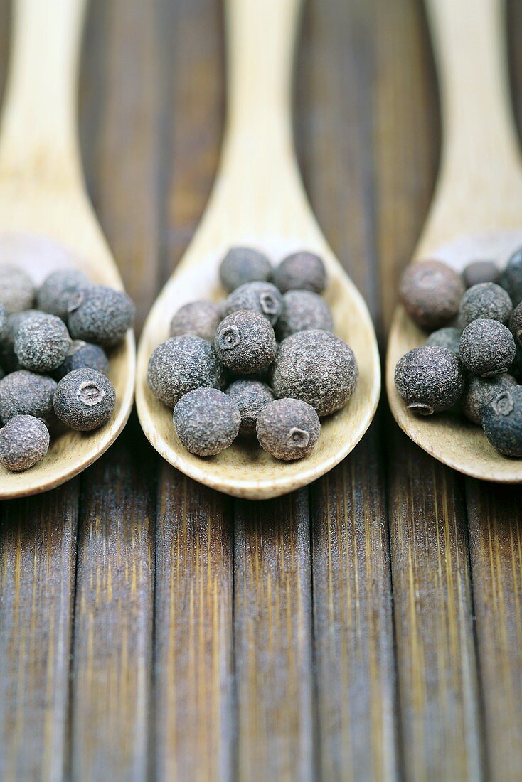 Allspice on three wooden spoons