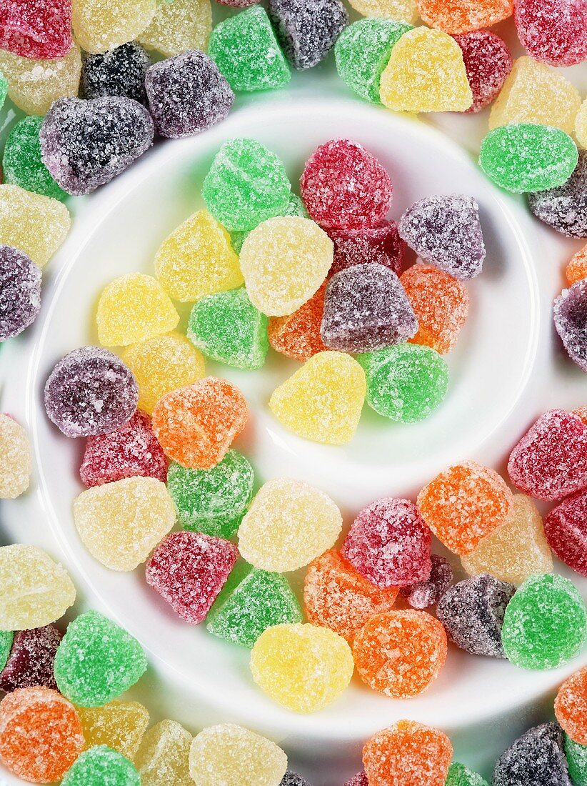 Sugar-coated fruit jelly sweets on a spiral plate
