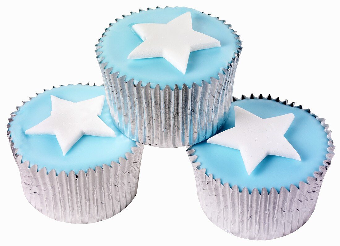 Three cupcakes with blue icing and stars