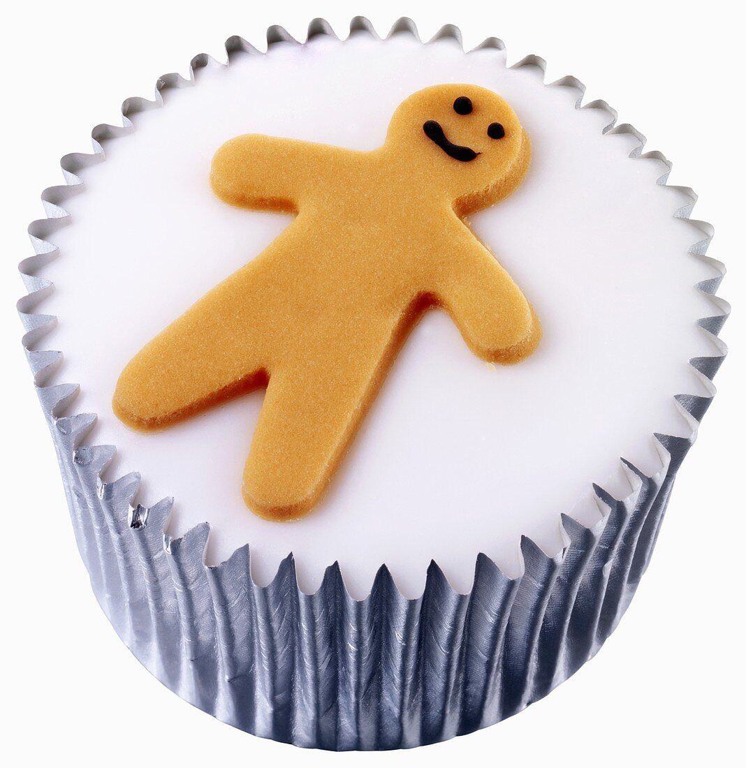 Cupcake with white icing and gingerbread man decoration