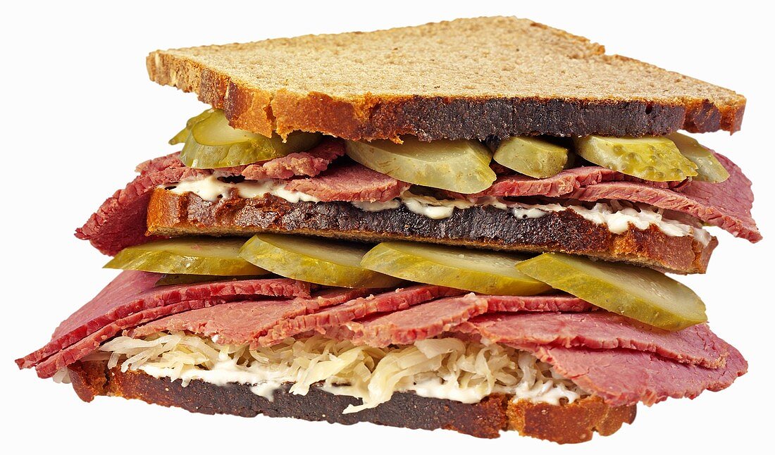 Double-decker corned beef, sauerkraut and gherkin sandwich