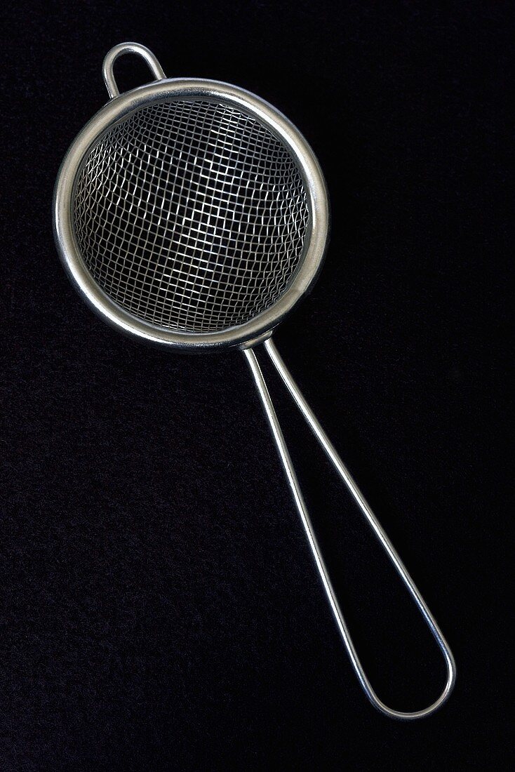 Small sieve against black background