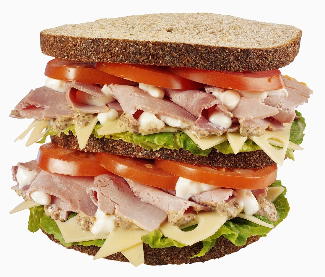 Double-decker ham, cheese, lettuce and tomato sandwich