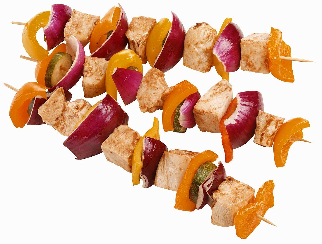 Three grilled chicken and vegetable kebabs