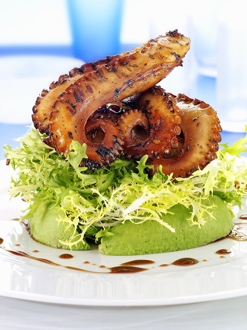 Grilled octopus on avocado salad