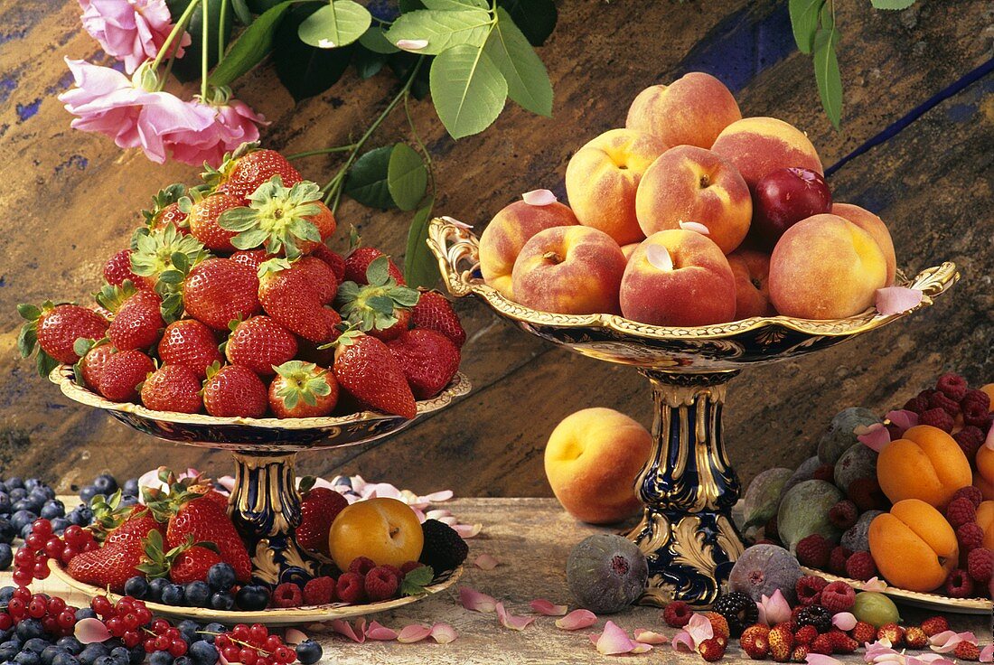 Still life with fresh berries, peaches, apricots, figs