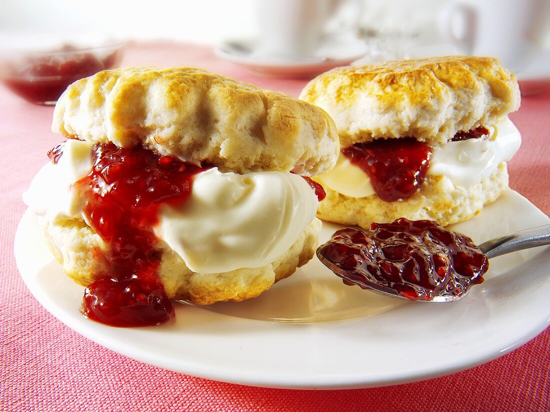 Two scones with jam and clotted cream
