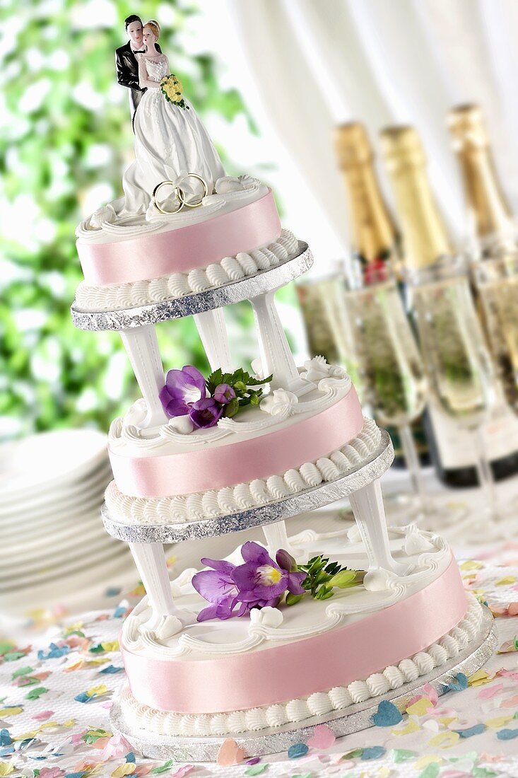 A three-tiered wedding cake with floral decoration