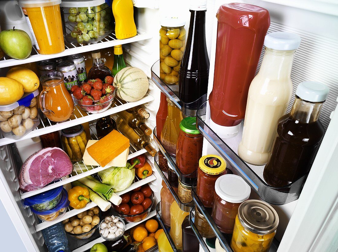 Many different foods in a refrigerator