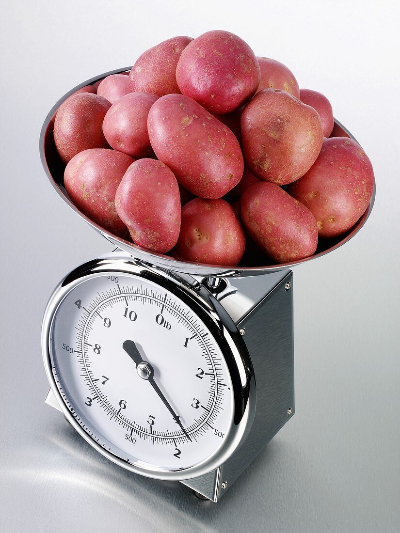 Red potatoes on kitchen scales