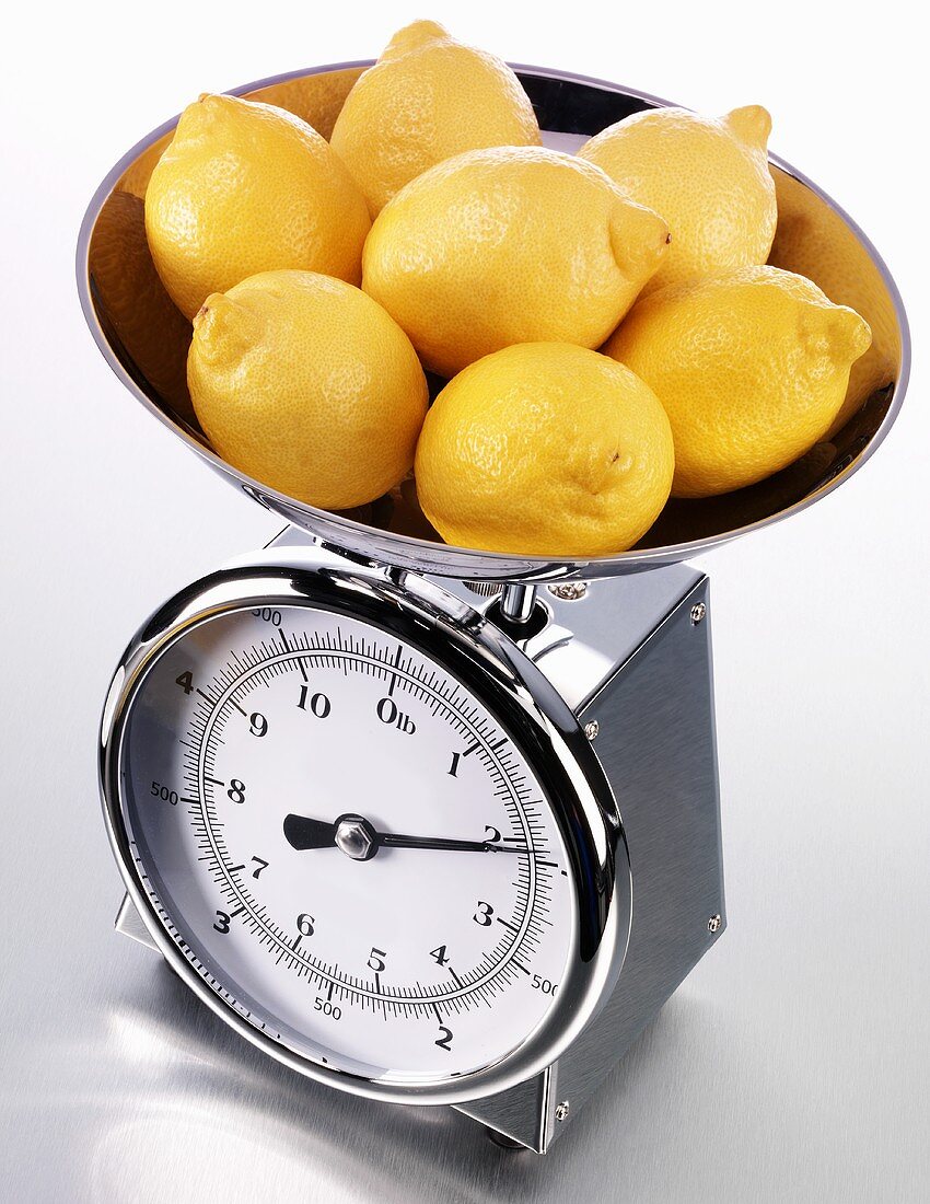 Fresh lemons on kitchen scales