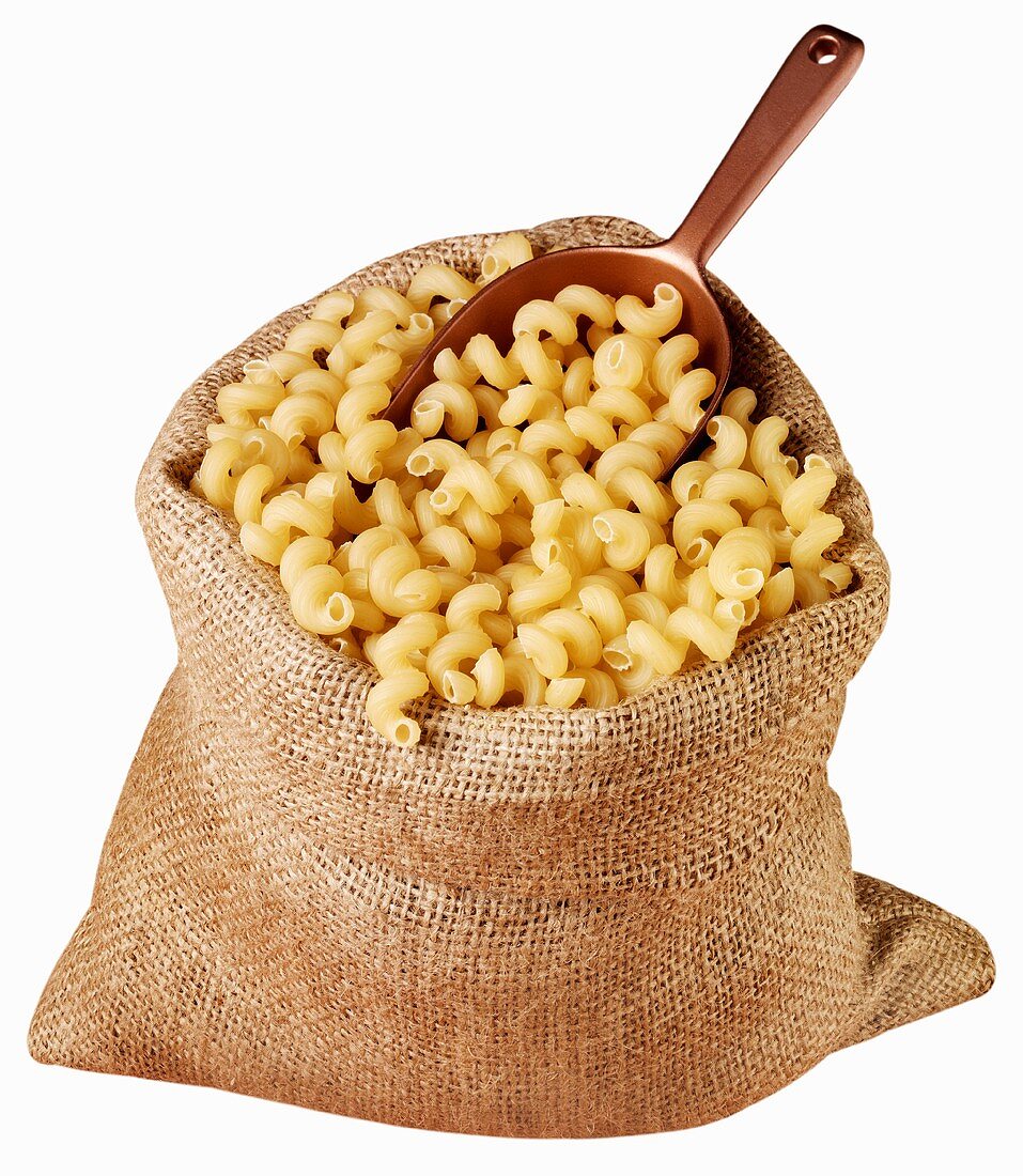 Pasta spirals in jute sack with scoop