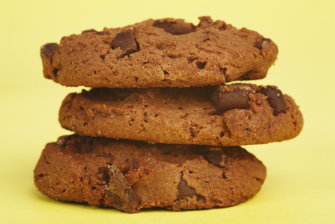 Three chocolate chip cookies in a pile