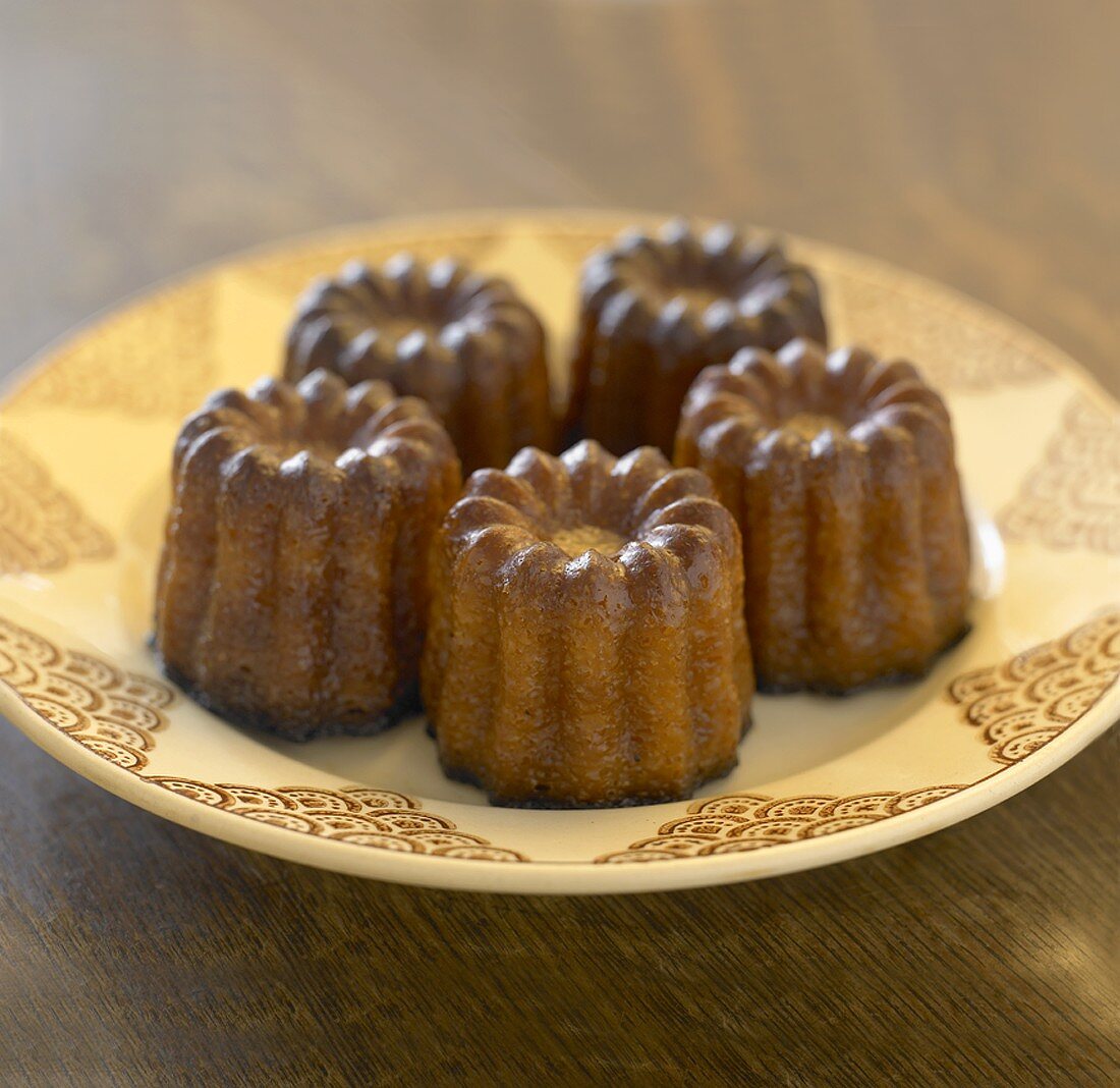 Four cannelés (Small cakes flavoured with vanilla & rum, France)