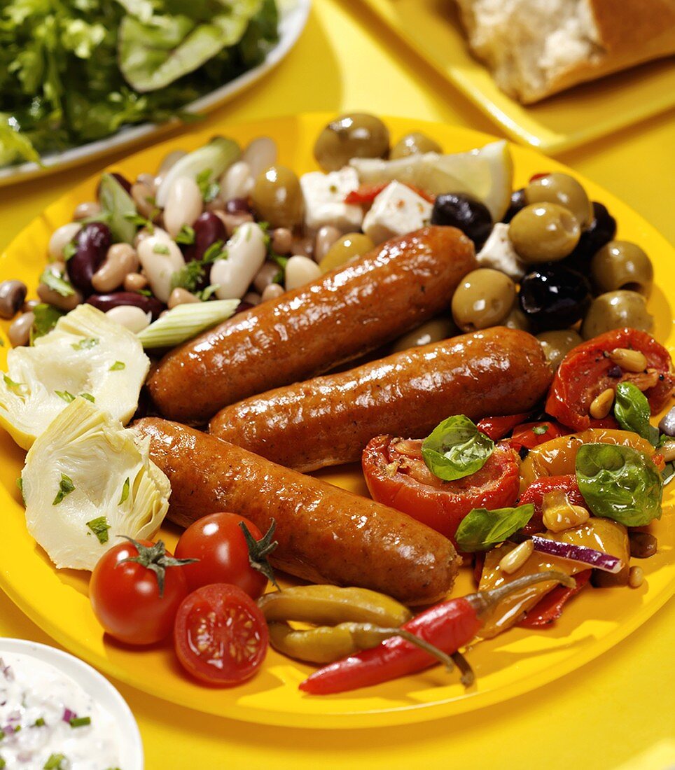 Fried chorizo sausages with vegetables and salad