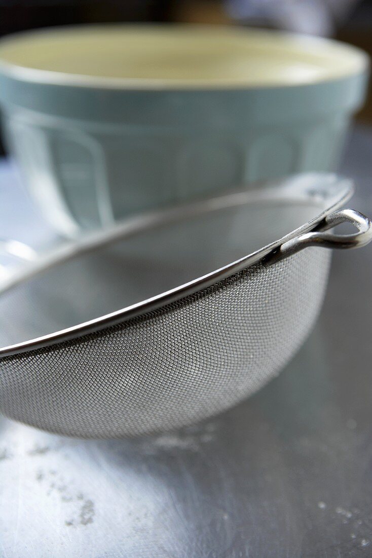 A sieve with a baking bowl in the background