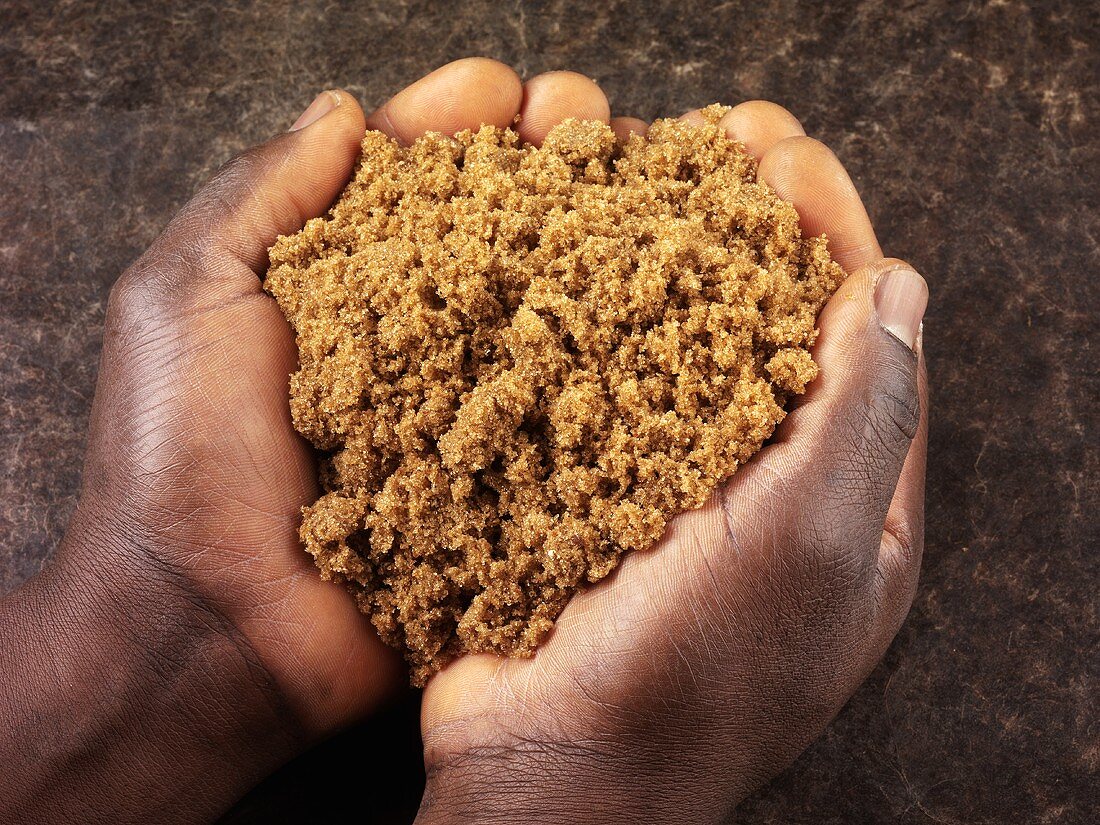 Hands holding brown sugar