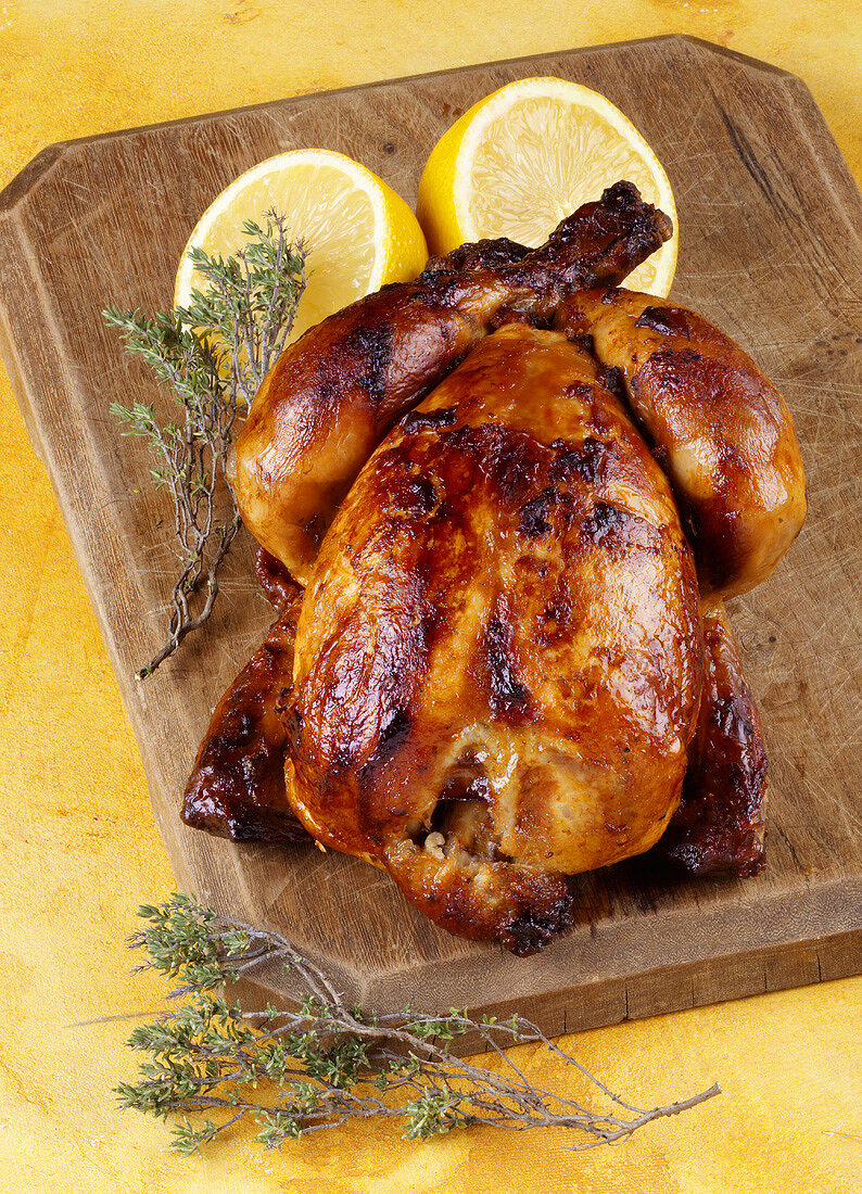 A whole grilled chicken with lemon and thyme