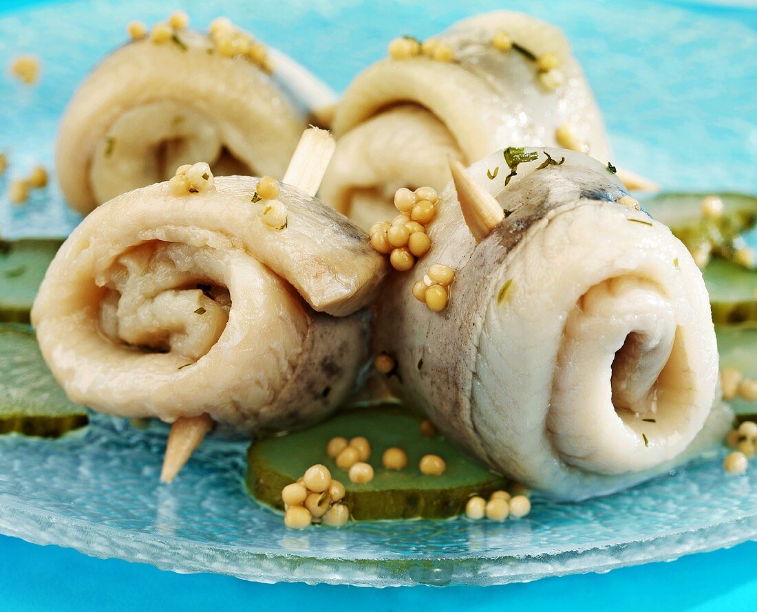 Four rollmops with gherkins and mustard seeds