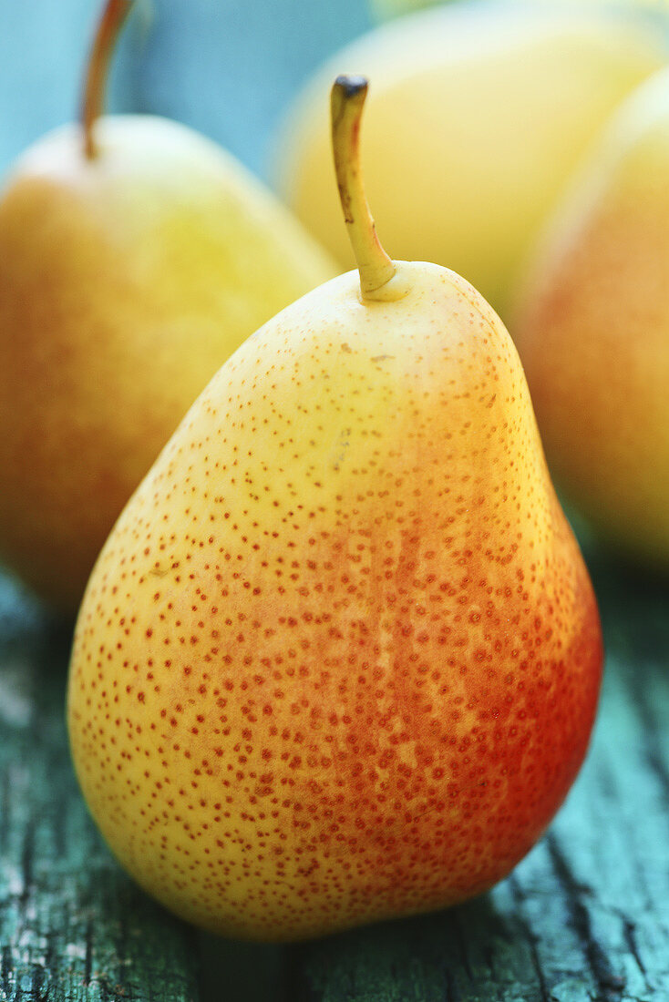 Several pears on a wooden background