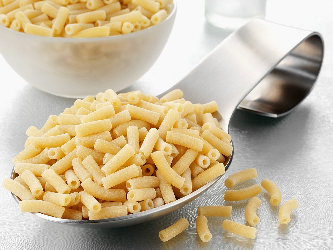 Macaroni on a spoon and in a bowl