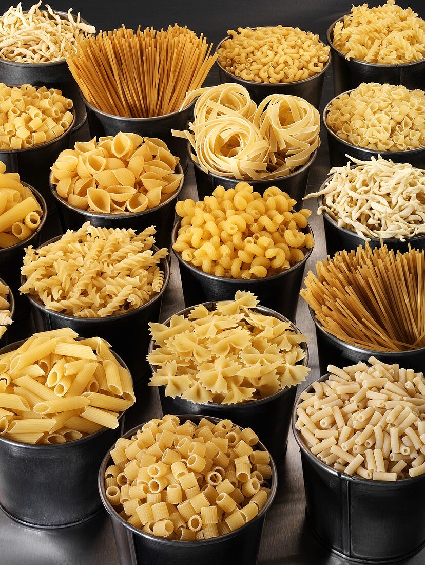 Various types of pasta in tubs