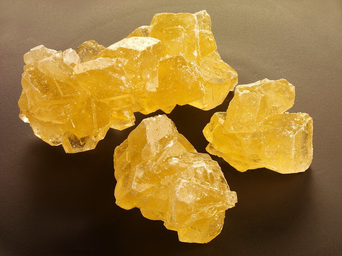 Three saffron sugar crystals