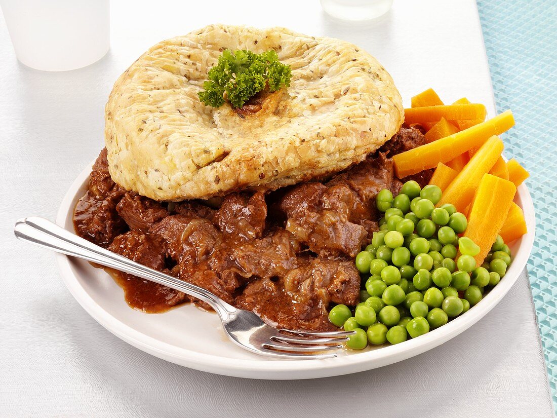 Beef and ale pie with peas and carrots