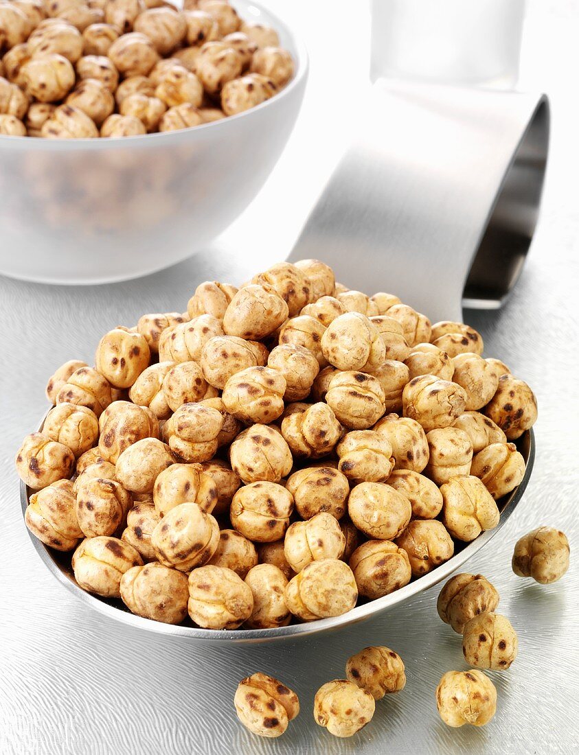 Roasted chick-peas on a spoon and in a glass bowl