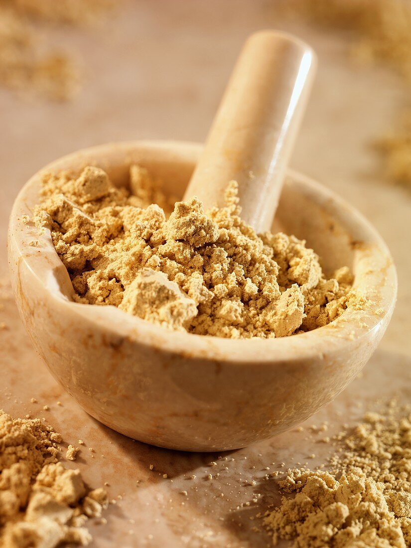 Crushed fenugreek in and beside a mortar