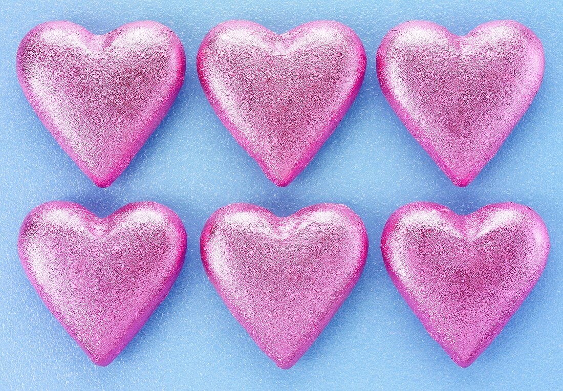 Six chocolate hearts in pink foil