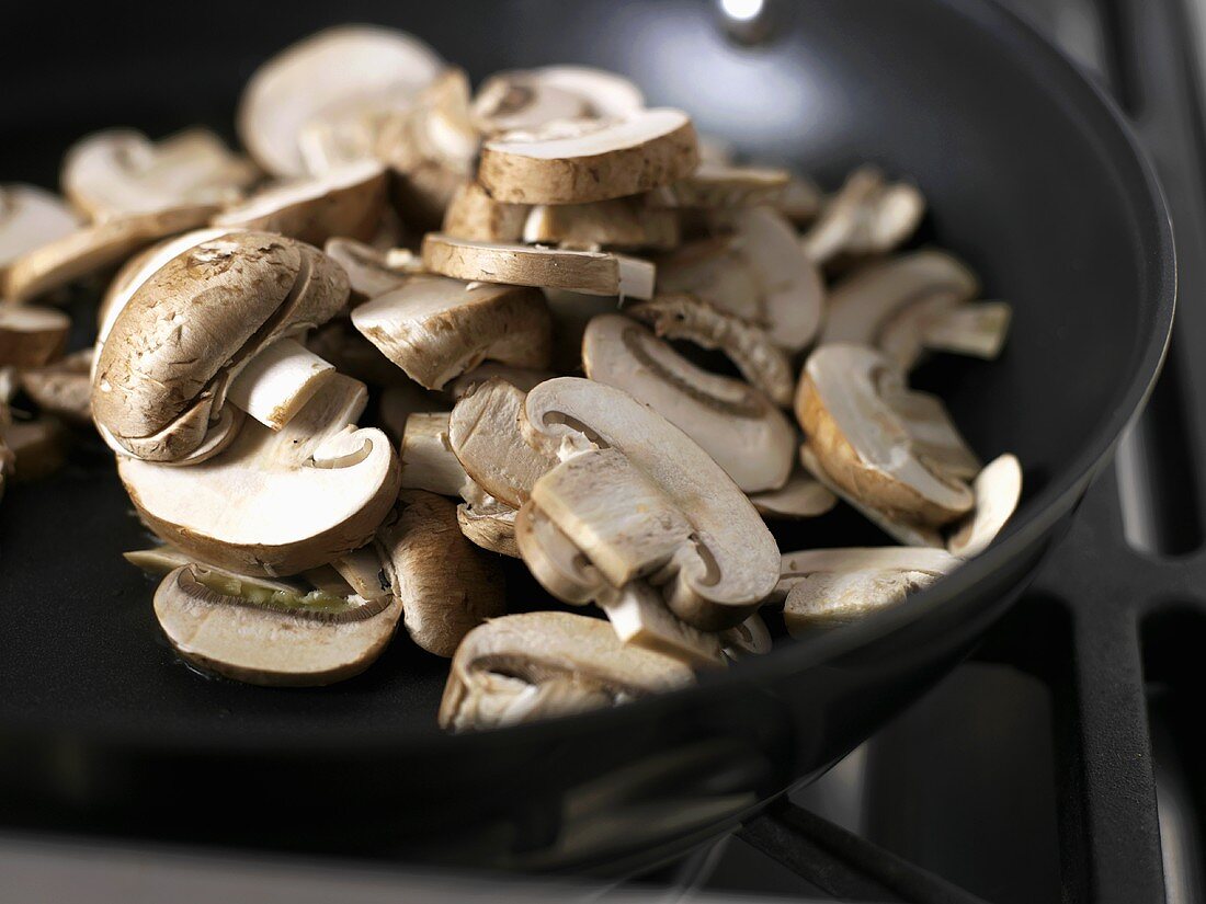 Sliced mushrooms in a frying pan