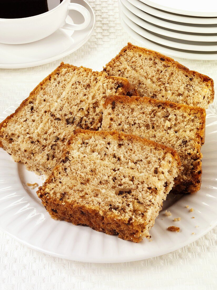 Four slices of walnut cake on a plate