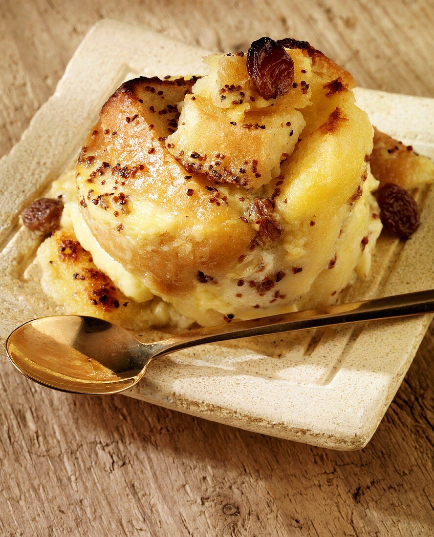 Bread and butter pudding on a plate with a spoon