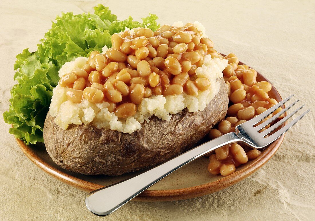 A baked potato with baked beans