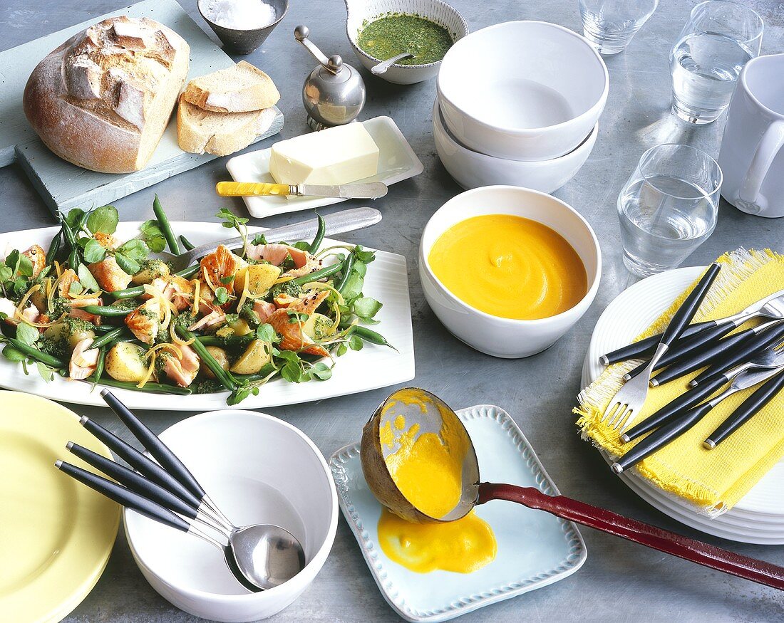 Carrot soup and potato, salmon and vegetable salad