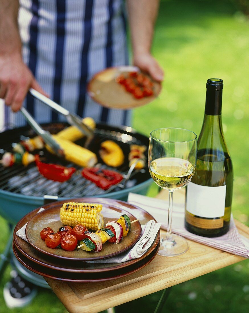 Grilled vegetables on a plate and on a barbecue