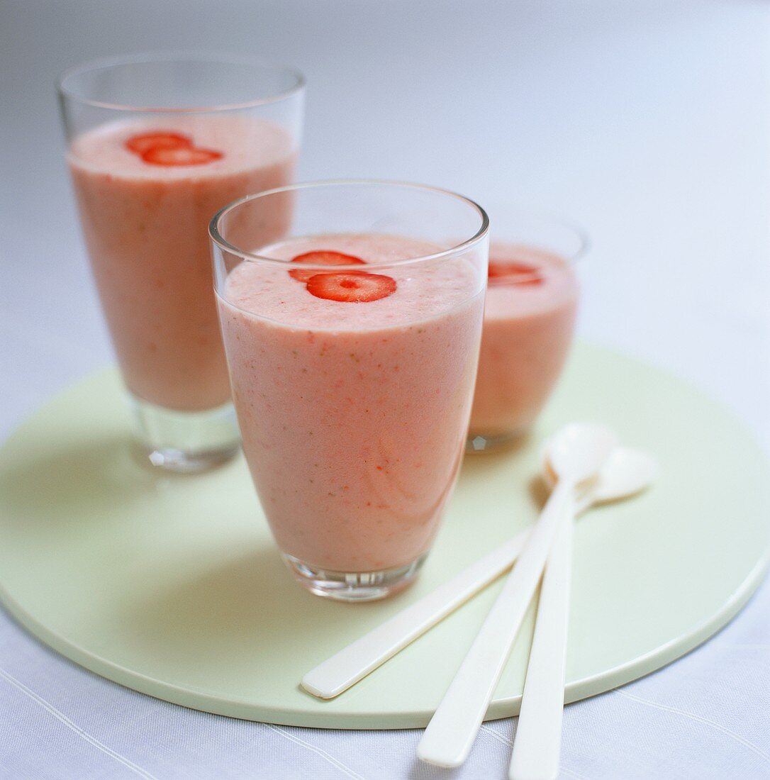 Three glasses of strawberry smoothie
