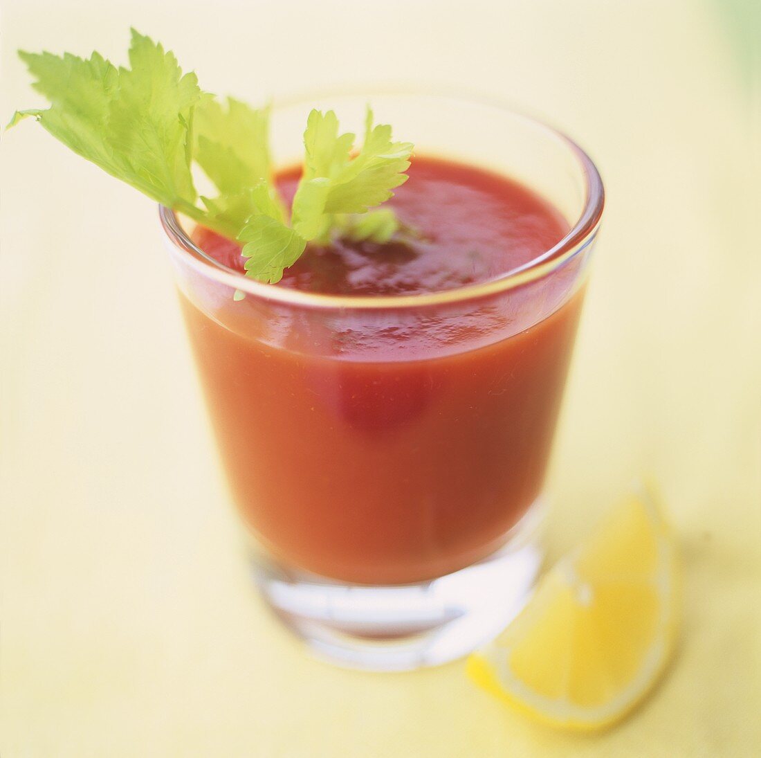 A glass of Bloody Mary with celery and lemon