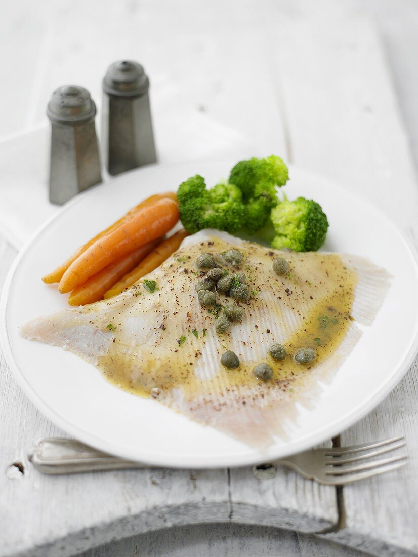 Poached skate wing with caper butter and vegetables